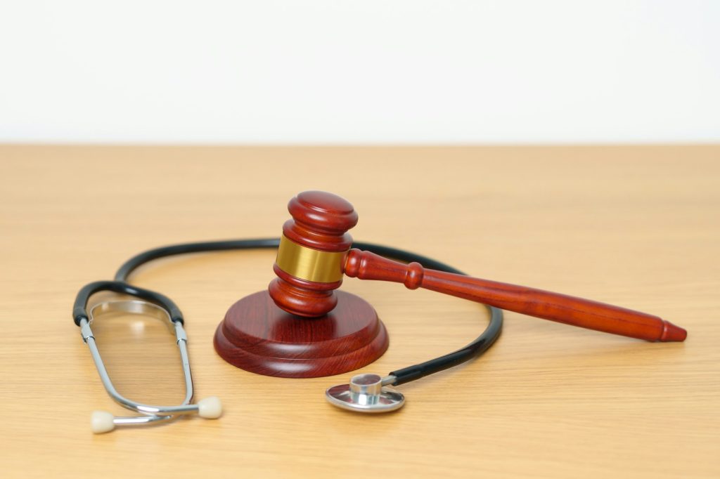 Gavel and stethoscope on table. Medical and Health Law, legal of medical malpractice concept